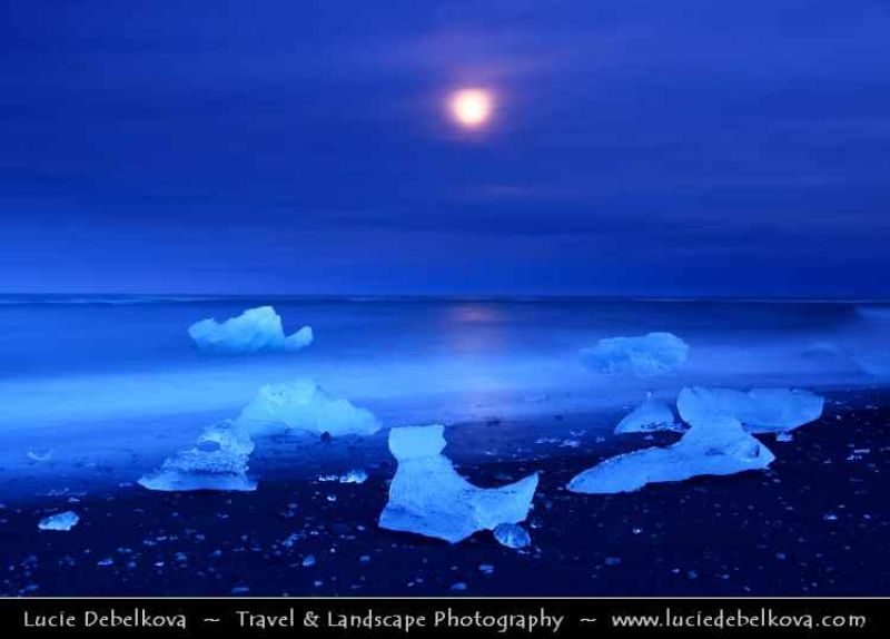 iceland - full moon over pieces of ice at black sand beach near jkulsrln glacier lagoon.jpg